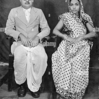 indian-couple-old-photo-sitting-on-chair-village-mahangwa-district-AAXY76