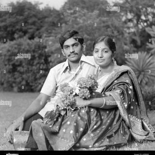 indian-man-woman-husband-wife-couple-sitting-lovingly-garden-india-A288M6