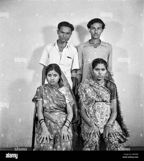 old vintage 1900s black and white studio portrait of indian family two brothers with their wives ind