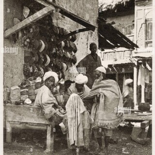 vintage-early-20th-century-photograph-hat-shop-srinagar-india-2HD5XRW